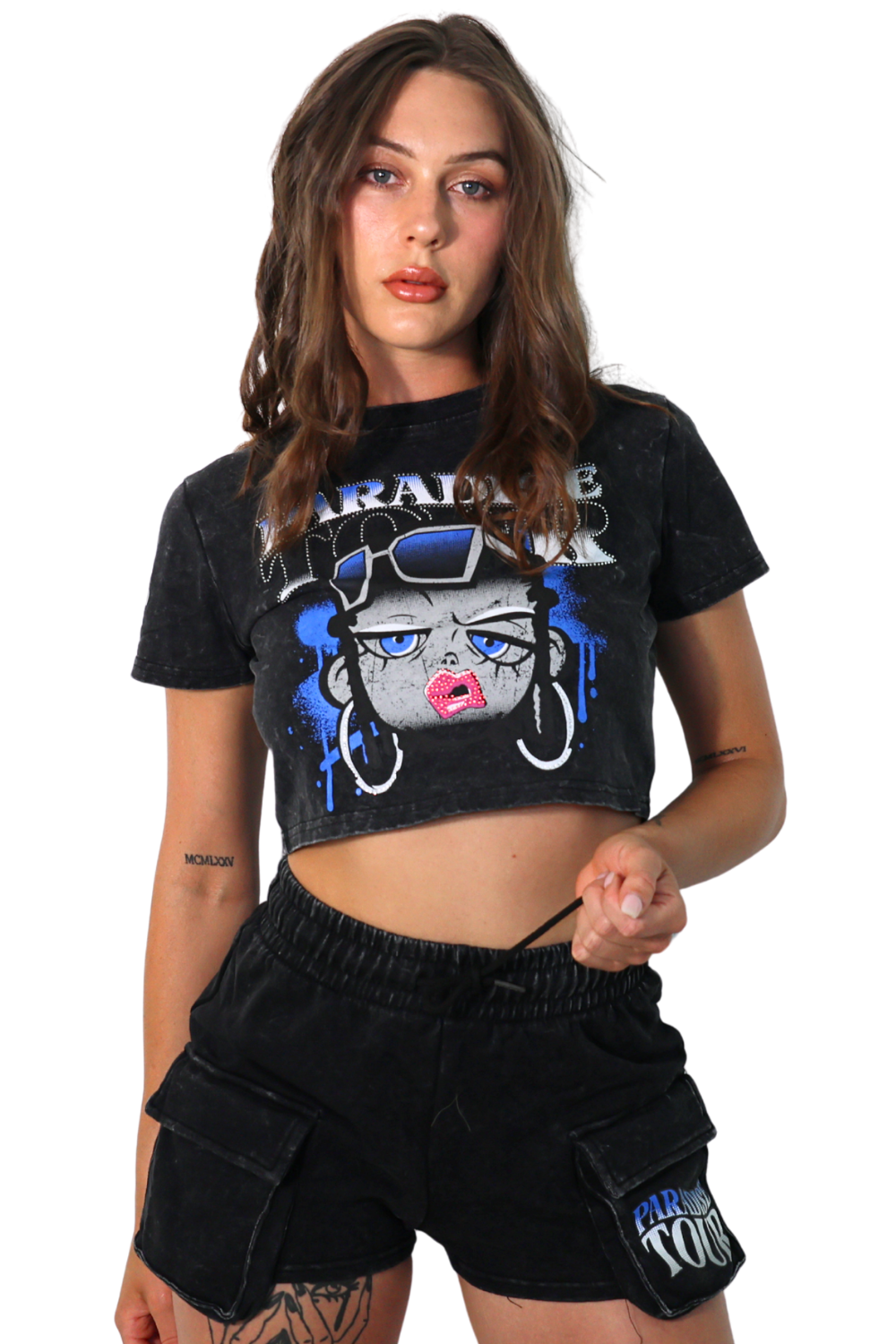 Woman wearing a black graphic t-shirt and shorts with a brand logo.