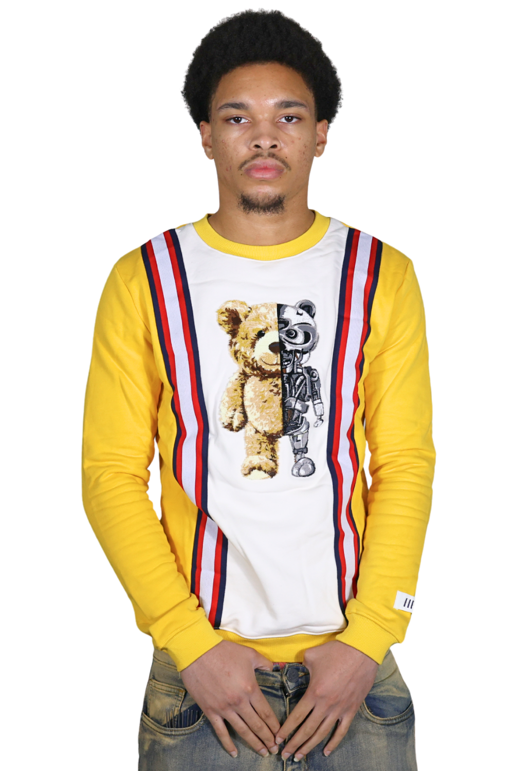 Person wearing a yellow long-sleeve shirt with a graphic design of a teddy bear and robot on a white background.