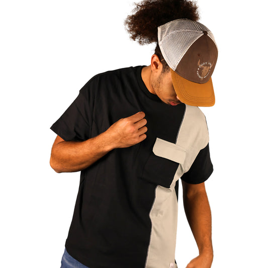 Person wearing a black and gray t-shirt with a cap on a white background